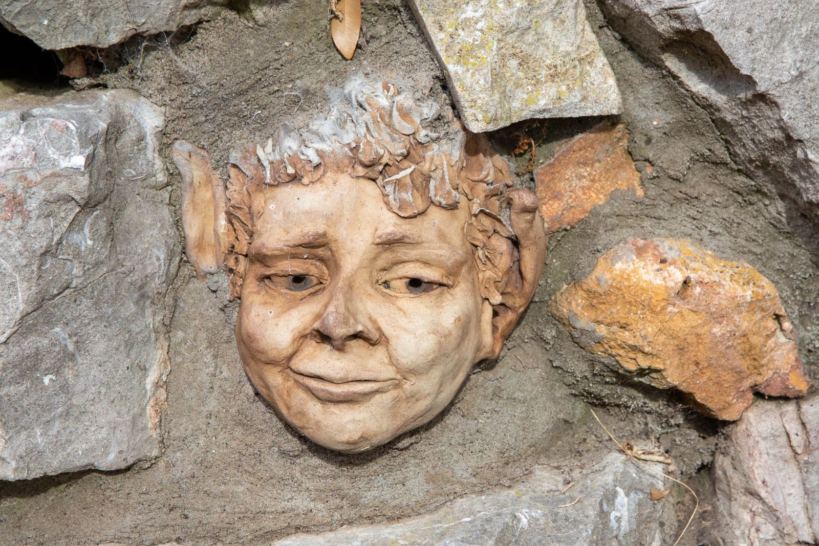 A goblin-style caricature of a face in a stone wall at the Prince Consort Gardens, Weston-super-Mare